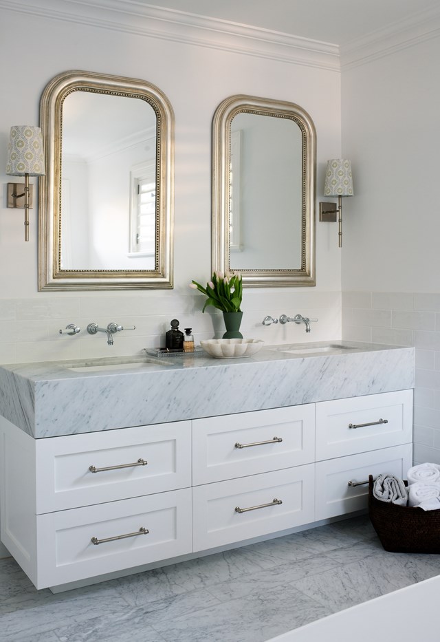 Often seen in pairs such as in [this bathroom](https://www.homestolove.com.au/classic-charm-home-sydney-22979|target="_blank"), as well as hallways or reading nooks, burnished metal wall sconces lend a classic Hamptons look to any space.