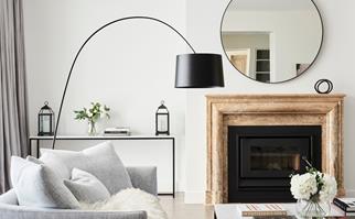 Living room with fireplace and large circular mirror