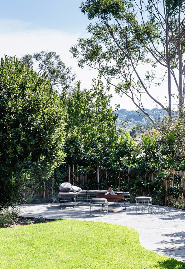 In the backyard of this [Mornington Penisular home](https://www.homestolove.com.au/serene-holiday-home-mornington-peninsula-22992|target="_blank"), this outdoor seating area centred around a fire pit is the perfect spot to take time out under the stars when the temperature drops.