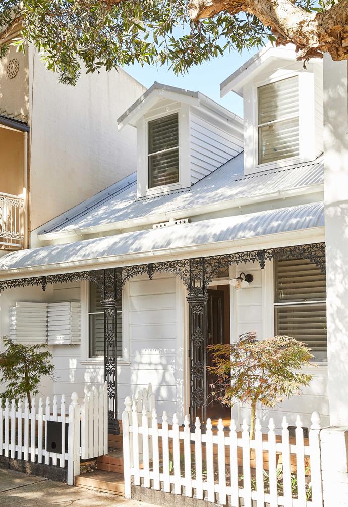 In keeping with this home's [19th century worker's cottage](https://www.homestolove.com.au/inner-city-terrace-cottage-renovation-23023|target="_blank") facade, a white picket fence with doube-panel gate demarcates the entrance. Beyond the property's front lies a modern, striking extension, which is given a nod by the contemporary mailbox.