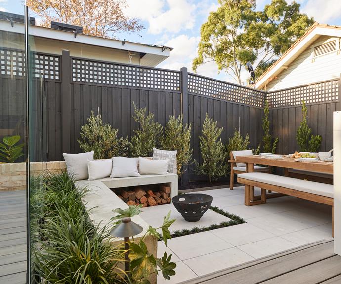 Ronnie and Georgia's statement [olive trees](https://www.allgreen.com.au/product-categories/fruit-trees|target="_blank"|rel="nofollow") lining the fence behind concrete bench seating, [firepit](https://www.schots.com.au/|target="_blank"|rel="nofollow") and large dining table. Landscaping by [Bayon Gardens](https://bayongardens.com.au/|target="_blank"|rel="nofollow").