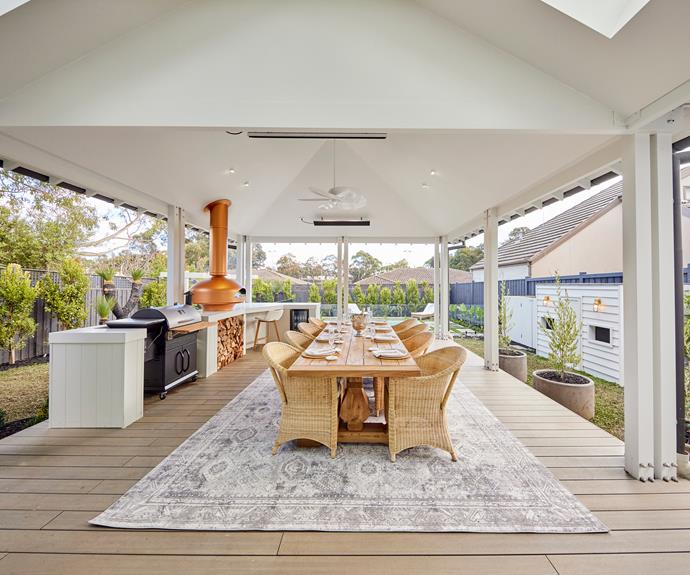Giant double doors off living area lead onto a pavillion area decorated in ultimate Hamptons style. Rug and tableware from [Freedom](https://www.freedom.com.au/product/24278553|target="_blank"|rel="nofollow").