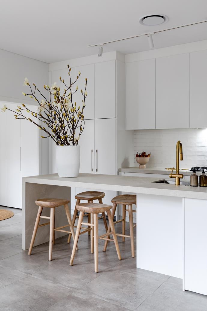 This [minimalist home in Sydney's eastern suburb of Randwick](https://www.homestolove.com.au/minimalist-federation-home-sydney-23067|target="_blank") serves as a calming, beautiful blank slate from which the owner, lawyer Catherine Wilson, was inspired to begin and build her ever-growing art collection. Lukily for Catherine, the kitchen needed little work, already coming adorned with a lush Caesarstone Cloudburst island and Sussex tapware, all of which is spotlighted by over-bench track lighting.