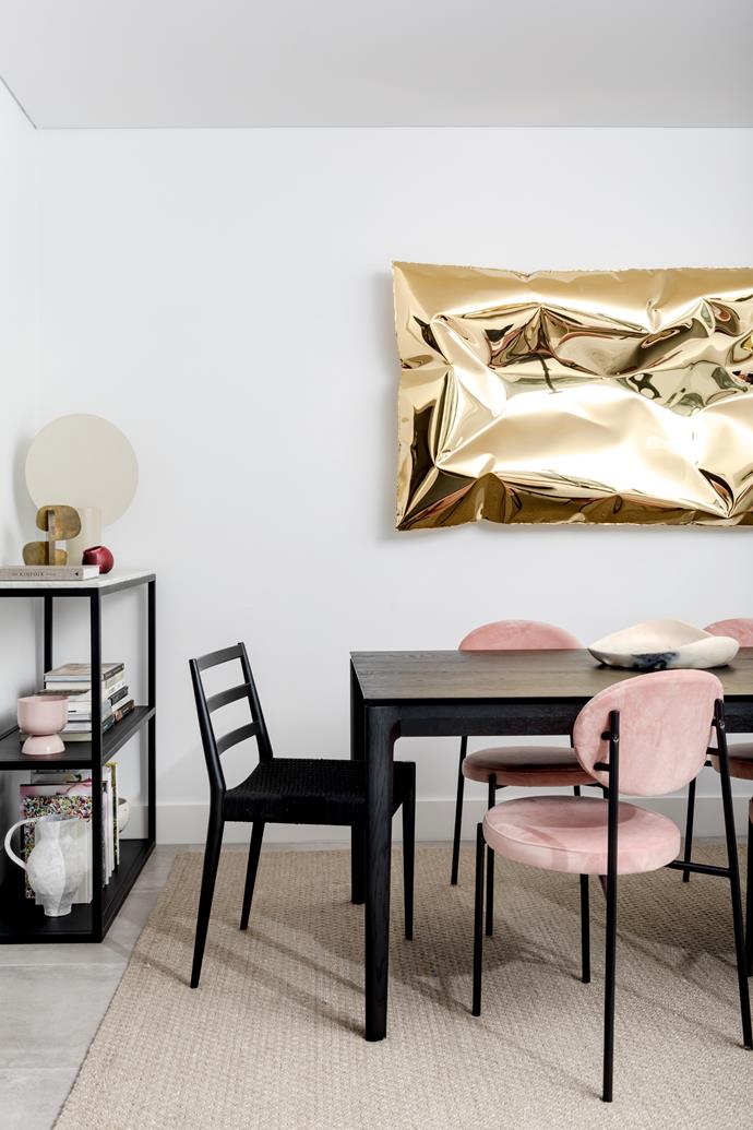 In the dining room, a black Ethnicraft 'Bok' table from GlobeWest and West Elm 'Holland' chairs make the Ben Storms artwork pop. The pink Sophie chairs are Brosa and the Sherpa rug is by Armadillo.