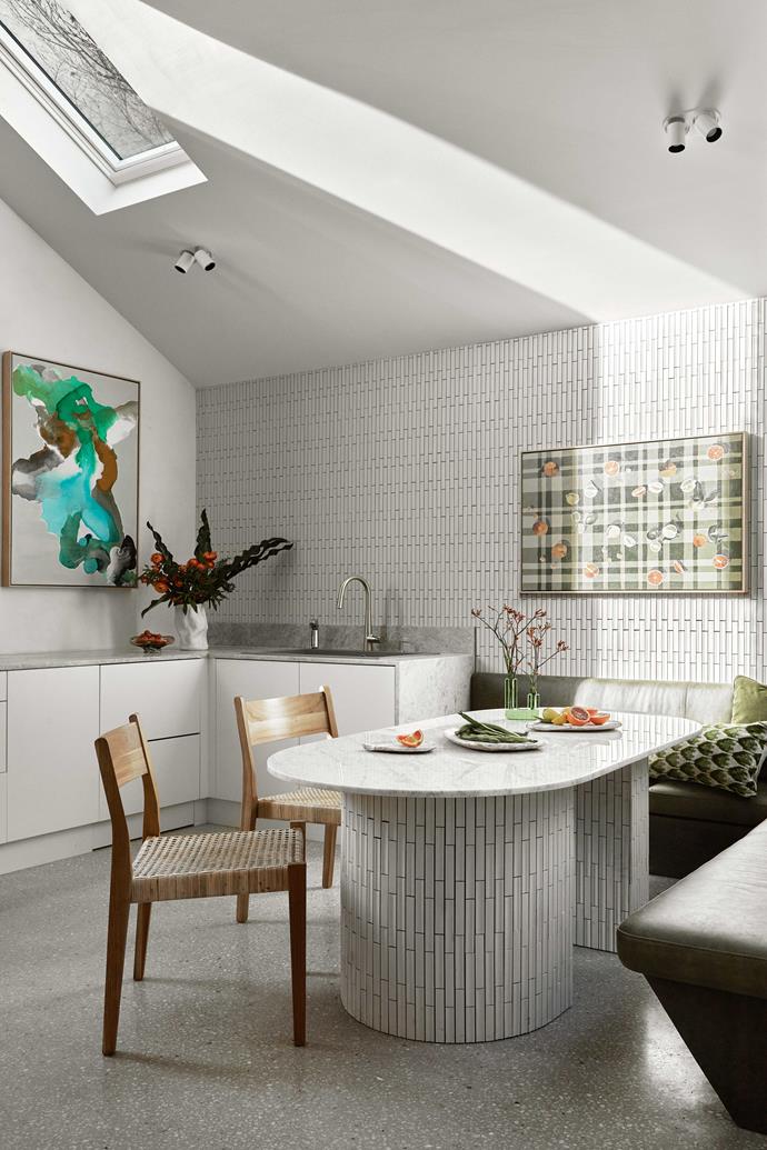 Soft greens create a sense of calm in the kitchen/dining area. Surrounding the custom-built, marble-topped island are [Willow Freya dining chairs](https://www.fentonandfenton.com.au/products/willow-freya-dining-chair-in-teak-rattan|target="_blank"|rel="nofollow") from Fenton&Fenton. The bench is upholstered in green leather and accessorised with [Zulta cushions](https://www.fentonandfenton.com.au/collections/all/products/zulta-cushion-in-green-palms|target="_blank"|rel="nofollow"). Artworks by [Sam Iurada](https://www.fentonandfenton.com.au/search?q=Sam+Iurada|target="_blank"|rel="nofollow") (left) and [Whitney Spicer](https://www.fentonandfenton.com.au/search?q=whitney+spicer|target="_blank"|rel="nofollow").