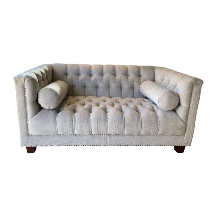 **['Manny' 2-seater sofa in oyster, $1000 (reduced from $1999), LM Home Interiors](https://lmhomeinteriors.com.au/product/manny-3-seater-sofa-in-oyster|target="_blank"|rel="nofollow")**
<br>
Contemporary and chic, the Manny 2-seater sofa will instantly elevate the look of a Hamptons inspired home. The boxy frame balances the curves of the classic, rolled arm rests. Deep cushioning means this sofa is as comfortable as it is good-looking.