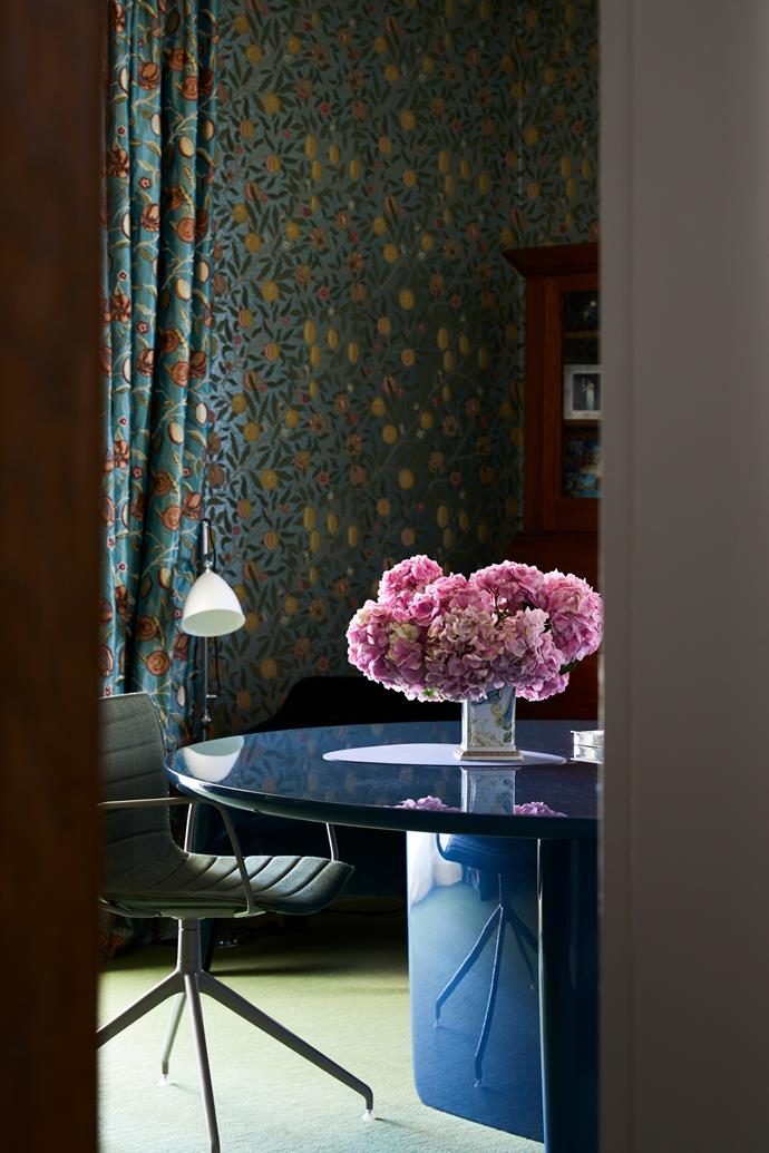 Pattern on pattern works beautifully with a floral curtain and adjacent wallpaper in this room by Nexus Designs.