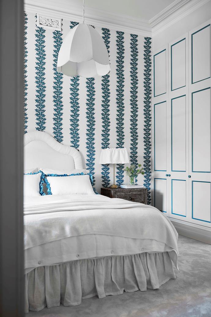 The main bedroom features Soane 'Osmunda Frond' wallpaper in Azure, and a pendant light from Fat Shack Vintage.