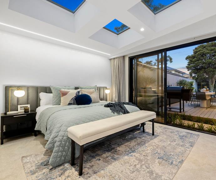 Master bedroom with sliding door, view of pool and four skylights