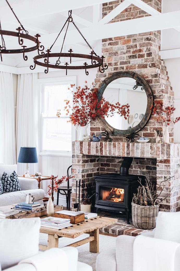 The wood-burning stove within the living room of the picturesque and utterly charming [Sinclairs of Berry](https://www.homestolove.com.au/sinclairs-of-berry-nsw-farmstay-23113|target="_blank") warms the whole living room. Though set up to sleep 14 with generously appointed bedrooms, this space was designed for gathering, and feels extra welcoming and cosy.