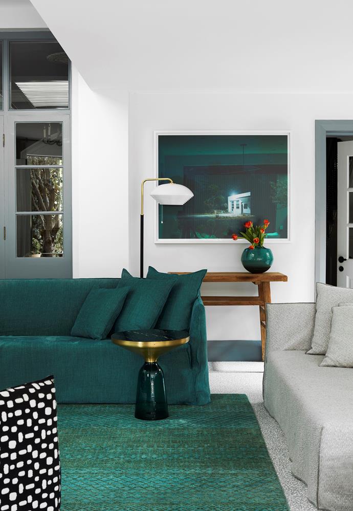 A Gervasoni 'Ghost 12' sofa by Paola Navone in teal is styled with a Blarney rug from Robyn Cosgrove. The walls are Porter's Paints Almond White, and the trims are French Slate.