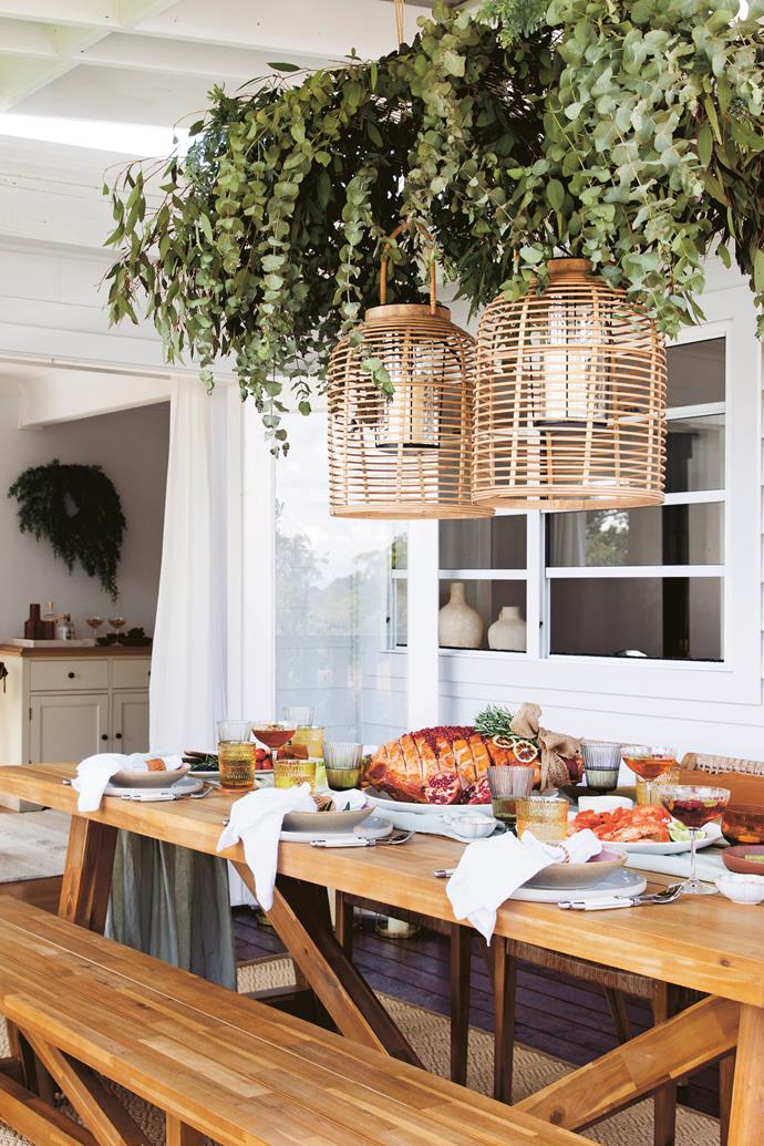 Celebrate all year round with stems of fresh or faux eucalyptus hanging enmasse above your dining table. Ensure lanterns are battery operated to avoid a fire hazard. *Photo: Chris Warnes*