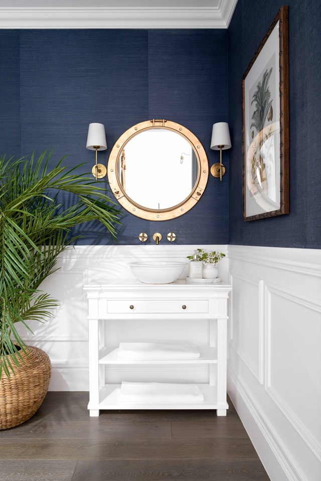 A striking Hamptons-style powder room echoes the decor of the rest of [this waterfront home](https://www.homestolove.com.au/hamptons-christmas-home-23131|target="_blank").