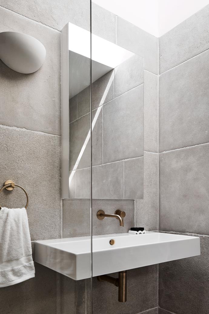 Large-format Calcetta tumbled limestone tiles from Eco Outdoor line the bathroom. The tapware and towel ring are by Gareth Ashton and were sourced at Abey.