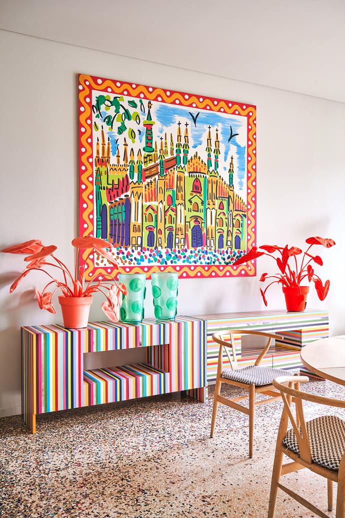 The vibrant print on the wall in the dining area was from a Missoni collection and features an image of the Duomo cathedral in Milan. The multicolour cabinet from the Salvatore + Marie atelier nods to Rosita's exuberant style. On top are felt plants from a craft fair and green Murano glass vases. Wishbone chairs by Hans Wegner.