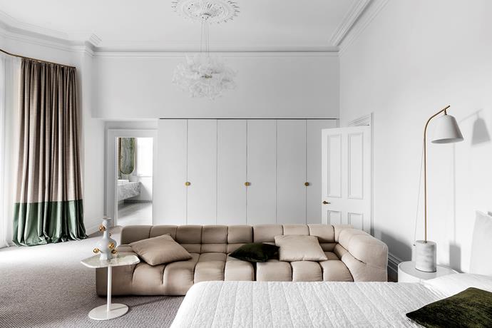 A cloud-like 'Fandango' pendant light from Hermon Hermon Lighting dances above the master bedroom's assembly of soft appointments in elegant shades of crisp white, taupe and olive green. B&B Italia 'Tufty-Time' sofa from Space. Marble side table from Meizai with Moooi 'Delft' vessel from Space. 'Salisbury 9 Ancient' carpet from Feltex. Bedside lamp from Meizai.