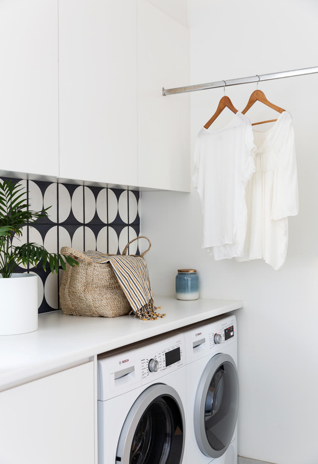A simple rod to hang clothes to dry saves time and energy in [this coastal laundry](https://www.homestolove.com.au/mid-century-modern-coastal-home-freshwater-22223|target="_blank"). *Photo: Simon Whitbread | Story: Home Beauiful*