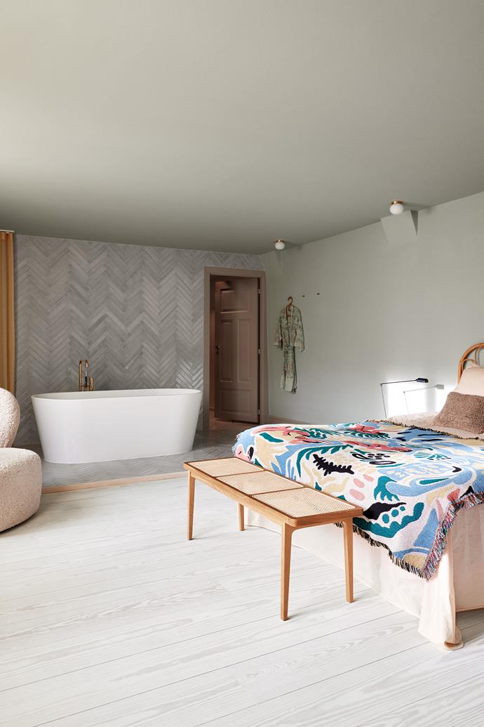 Mornings in the bedroom begin with a soak in the tub, which basks in natural light from the windows. Christine says this room was designed to have "a hotel feeling" with a headboard and bedspread from [Beau Marché](https://beaumarche.dk/|target="_blank"|rel="nofollow"), bedding from [Aiayu](https://www.aiayu.com/|target="_blank"|rel="nofollow"), a [Norr11](https://norr11.com/|target="_blank"|rel="nofollow") cane bench, [Flos](https://www.flos.com/|target="_blank"|rel="nofollow") ceiling lights and a freestanding tub with [Vola](https://en.vola.com/|target="_blank"|rel="nofollow") tapware. Shimmering [File Under Pop](https://www.fileunderpop.com/home|target="_blank"|rel="nofollow") tiles delineate the raised bath area. The paint colours create a sense of continuity with the rest of the home.