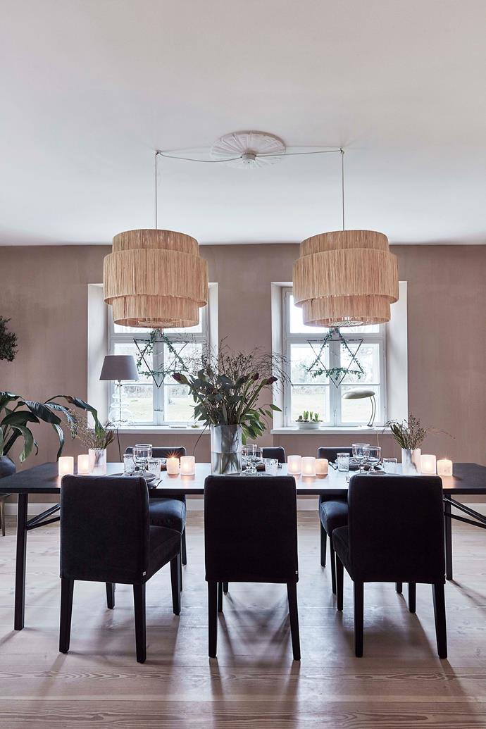 The dining room features designer furniture, but with an exotic twist in the form of raffia lamps and green plants.