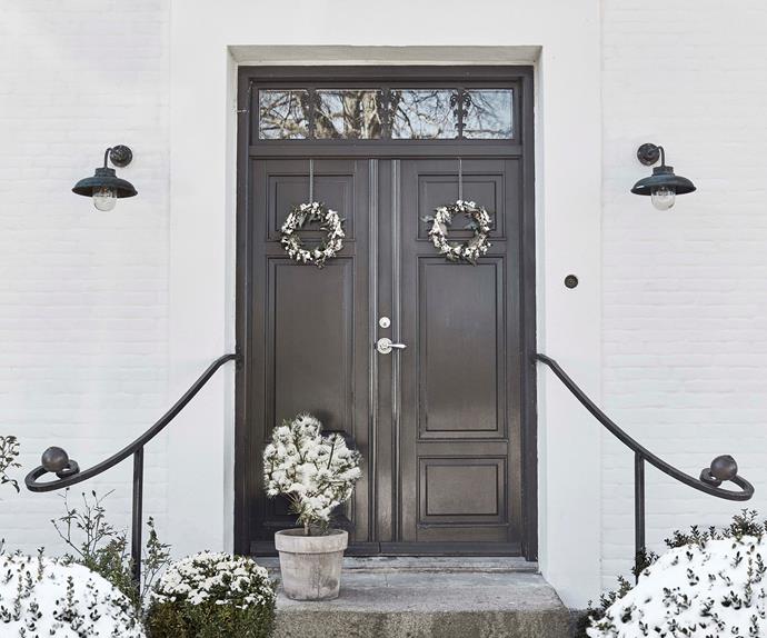 Black front doors of a home in Denmark
