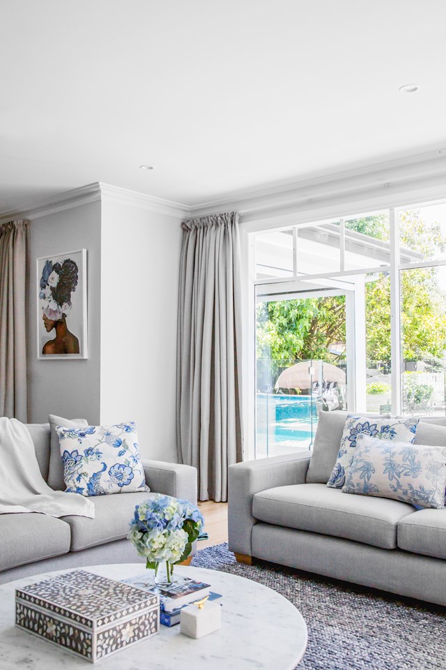 Blue tones continue outside through wide windows that welcome natural light and a verdant outlook to the pool and [Hamptons style garden](https://www.homestolove.com.au/hamptons-style-garden-design-tips-22811|target="_blank"|rel="nofollow") in [this bayside Melbourne home](https://www.homestolove.com.au/bayside-hamptons-forever-home-23193|target="_blank").