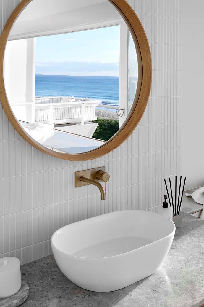 There's no need for colour in this neutral-toned bathroom, which benefits from unmatched views of its beachfront loation. The [1950s fibro cottage](https://www.homestolove.com.au/waterfront-fibro-house-renovation-23071|target="_blank"), located on Queensland's coastline, was a knock-down in the eyes of others, but owners Harry and Georgia saw its potential. In the ensuite, kit-kate tiles that line the walls are from Edge Tile+Stone, and the marble benchtop provides texture.
