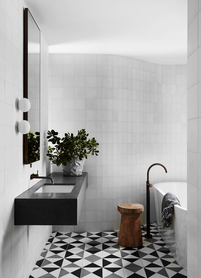 The [children's bathroom in this heritage house](https://www.homestolove.com.au/heritage-house-contemporary-renovation-22861|target="_blank") stuns with a wavy wall, small round sconces and a statement arching tap. 