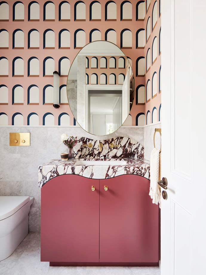The bathroom in this [elegant 1890s terrace](https://www.homestolove.com.au/elegant-1890s-terrace-transformation-22429|target="_blank") is covered in curves. From the oval mirror to the wavy-edged vanity, you can even see curves in the wallpaper pattern. 