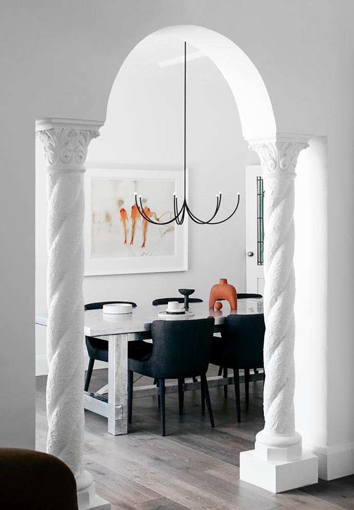 Archways and columns serve plenty of drama in the dining room of [this Spanish-mission style home](https://www.homestolove.com.au/renovated-spanish-mission-home-21178|target="_blank") with a sophisticated renovation. 