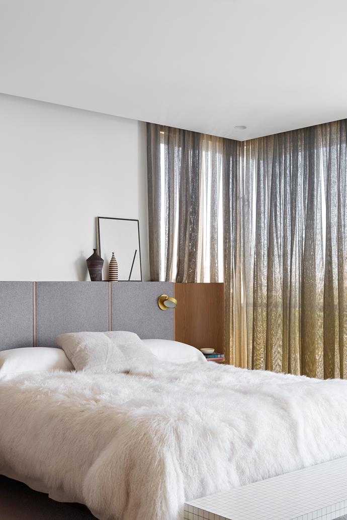 In the master bedroom, a subtly curved bedhead resembles a rolling wave. "We constucted it around the bed and intricately matched the tops of the bedsides with the height of the mattress," Joel tells. A [RBW](https://rbw.com/|target="_blank"|rel="nofollow") 'Monocle' sconce lights the space, while an artwork by [Clay Mahn](https://www.twfineart.com/collections/clay-mahn|target="_blank"|rel="nofollow") sits on top of the bedhead.