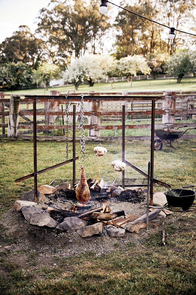 Meat roasting over the [fire pit](https://www.homestolove.com.au/fire-pit-ideas-21403|target="_blank").