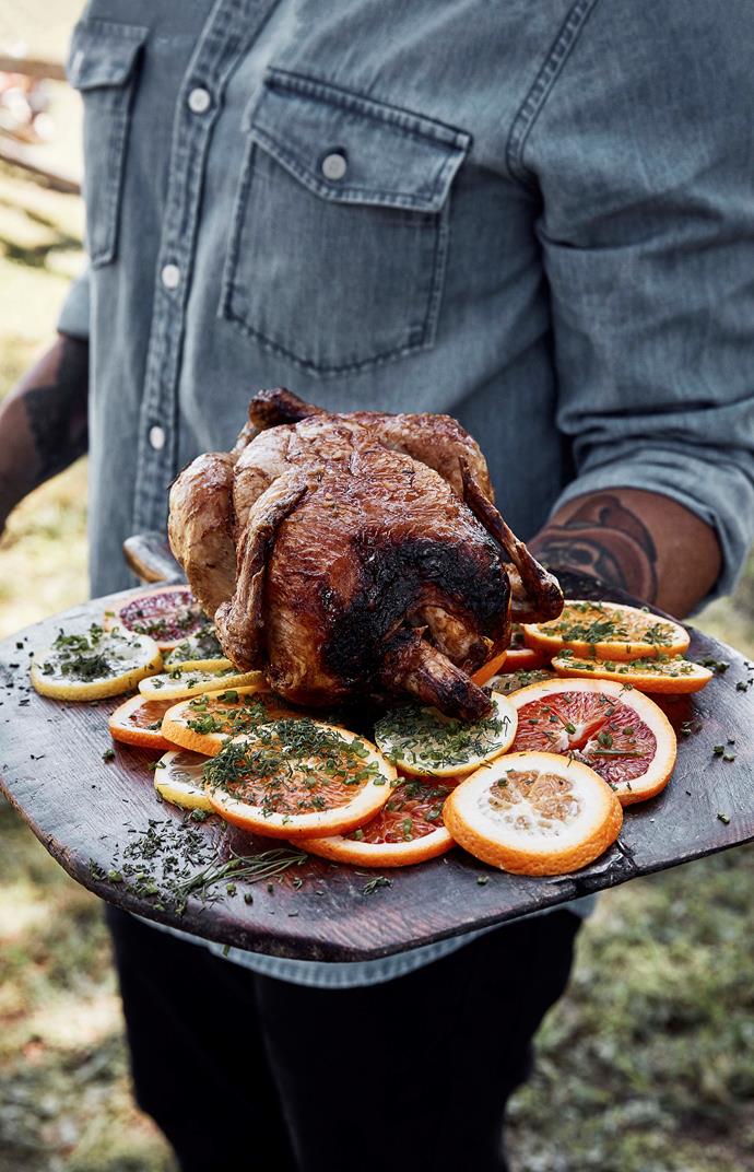 Charred campfire [roasted chicken](https://www.homestolove.com.au/how-to-roast-chicken-9163|target="_blank") served with fresh orange and lemon slices.