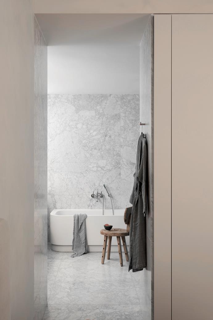 In the ensuite, the stool is from Watertiger. The existing bath, tapware and marble flooring were retained.