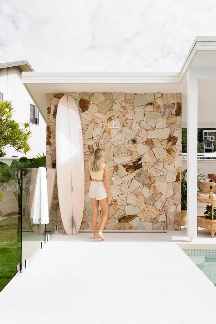 **OUTDOOR SHOWER** Finding the perfect stone for the feature wall by the pool was a priority. "A lot of people have commented how much they love the stone, but unfortunately it's no longer available," says Kellie. Bella can take her pick from the couple's vast surfboard collection – one of her favourites is the 'Cinnamon Girl' board by Mitchell Surman Surfboards.