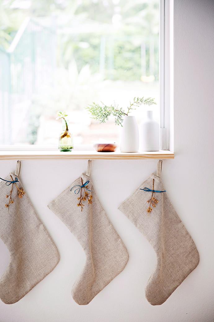 Hang stockings in the hallway or beneath a window to evoke a Christmas atmosphere.
