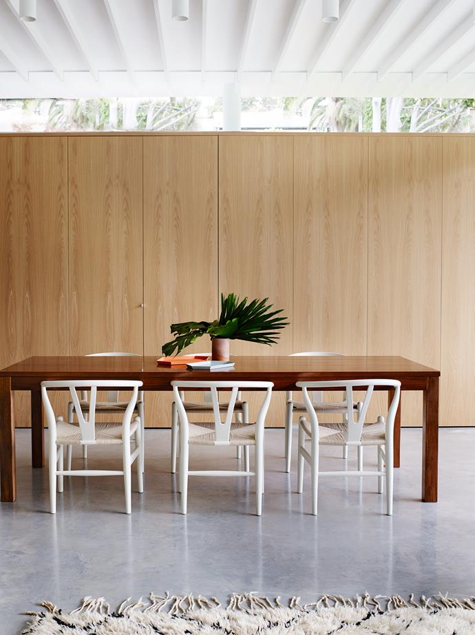 Polished concrete floors in the dining room of this [Sydney home](https://www.homestolove.com.au/modernism-inspires-laid-back-family-home-2762|target="_blank") offset the custom-made European-oak joinery.