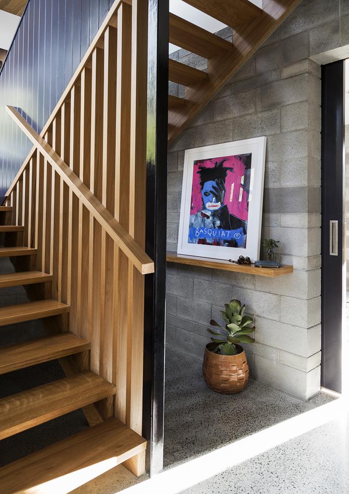 In the downstairs foyer of this [Brisbane home](https://www.homestolove.com.au/gallery-laura-and-alistairs-contemporary-family-home-1719|target="_blank"), a handy shelf by the front door is simply dressed with a Jean-Michel Basquiat art print from Jamieson's Home & Fashion.