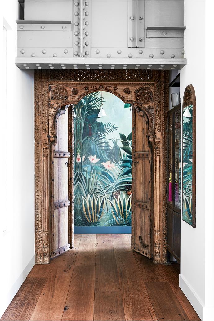 The mural wall is Henri Rousseau's The Equatorial Jungle, available from [Society6](https://society6.com/|target="_blank"|rel="nofollow"). "We don't have a balcony or garden," says Nicole, "so it brings a sense of nature into the apartment." Indian doors, Caravanserai.