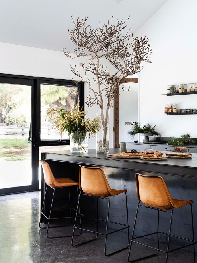 Natural light saturates the kitchen, which features bar stools by Coco Republic.