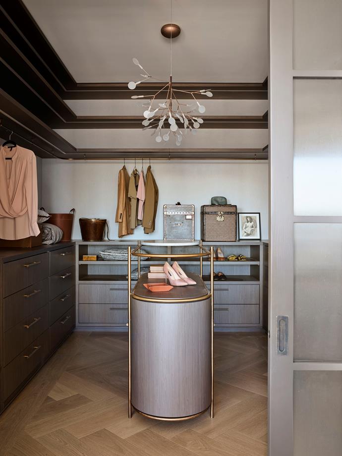 In the walk-in robe, a Moooi 'Heracleum Endless' pendant light from Space. Vintage hat boxes from Palmer & Penn and Maison et Jardin. Leather basket and containers from Great Dane.
