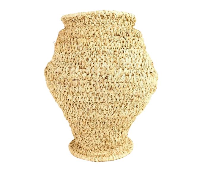 **[Raffia basket by Margaret Dodd, $495, Tjanpi Desert Weavers](https://tjanpi.com.au/collections/baskets/products/margaretdodd_1301-21|target="_blank")** 
<br></br> 
Tjanpi Desert Weavers is a social enterprise of the Ngaanyatjarra Pitjantjatjara Yankunytjatjara (NPY) Women's Council which gives women in remote Central and Western desert regions the opportunity to earn an income from contemporary art. This piece was created by Margaret Dodd, an artist known for her distinctive aesthetic and vessels woven in an organic, loose style.