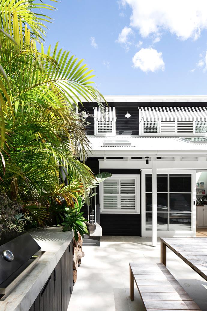 **EXTERIOR** Celebrating the holiday vibe, a joyous coastal exterior is created thanks to Dulux Black and Dulux Lexicon Quarter, striped awnings and shutters from [Bayside Shutters and Blinds](https://baysideshuttersandblinds.com.au/|target="_blank"|rel="nofollow"), and wall lights from Beacon Lighting's Portsea range. Mullioned doors nod to the [English cottages](https://www.homestolove.com.au/traditional-english-style-country-cottage-12235|target="_blank") Emma loves: "Each square frames a different view of the garden – it's lovely."