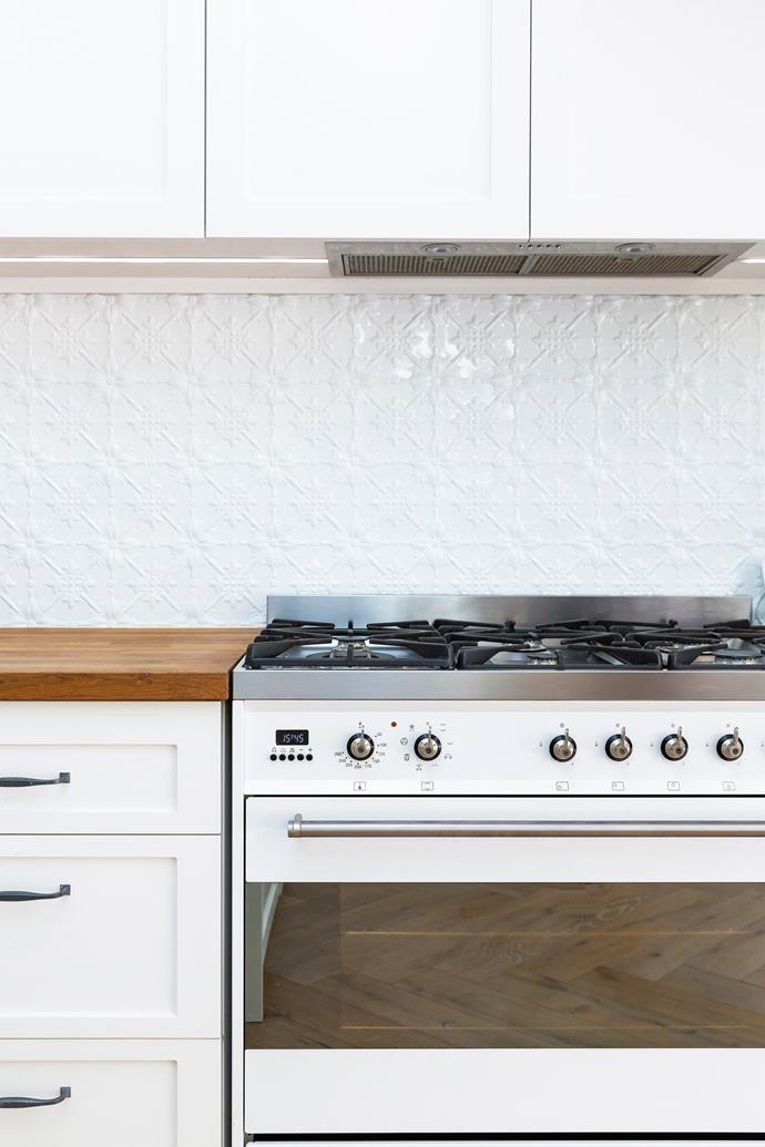 **KITCHEN** A white freestanding Smeg oven is the perfect choice for a coastal kitchen and pressed tin tiles add interest and texture.