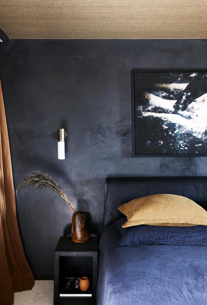 [This unique apartment in Bondi](https://www.homestolove.com.au/unique-bondi-apartment-19689|target="_blank") is a textural wonderland, peppered with unexpected and playful details, including a sumptuous black Marmorino render in the bedroom which is paired with a Cassina 'Cab' bed from Cult and navy Jardan bedlinen. 