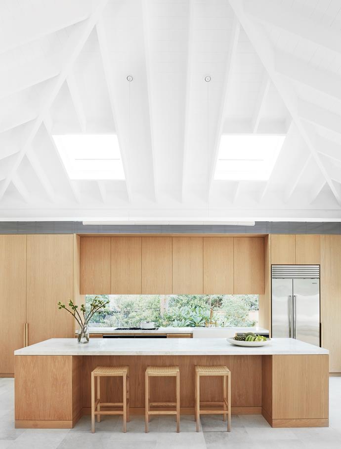 With a beautiful view out the garden, this stunning oak veneer kitchen is light and breezy, and perfectly suited to its coastal setting. Built as a series of pavilions, the pitched ceiling gives [this Palm Beach home](https://www.homestolove.com.au/modern-mediterranean-coastal-home-palm-beach-21958|target="_blank") a touch of the Mediterranean. 