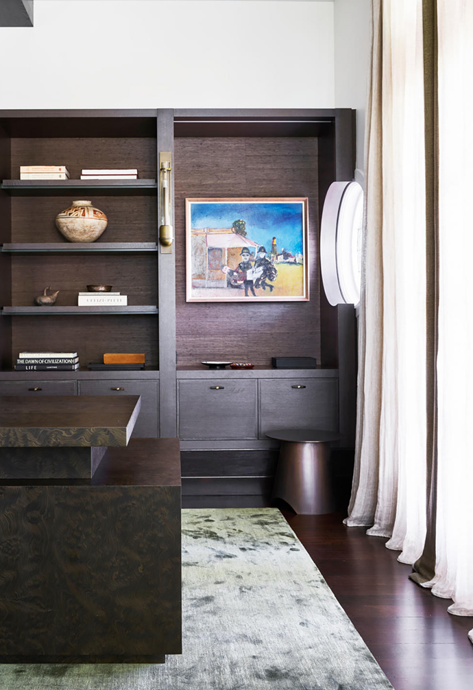 A piece by Sidney Nolan pops against the dark joinery in the office of [this luxurious coastal home](https://www.homestolove.com.au/luxurious-coastal-home-with-australian-art-21172|target="_blank") of an avid Australian art collector.
