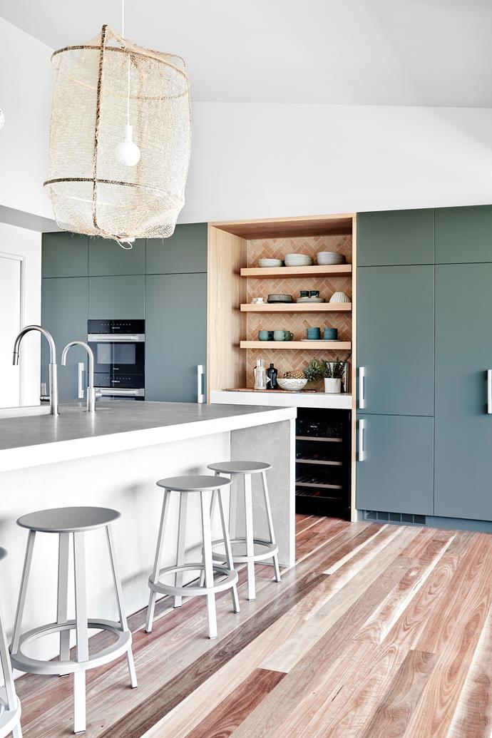 "The splashback's terracotta tiles from Sydney's [Barefoot Living](https://www.barefootliving.com.au/|target="_blank"|rel="nofollow") blend in with the forest green of the kitchen cabinetry, which is Deep Bottlebrush by Dulux," says interior designer [Louise Walsh of LWID](https://www.louisewalsh.com.au/|target="_blank"|rel="nofollow"). Concrete (on the benchtops) and American oak timber also tie in. Hardware, Handmade & Found. Zip tapware, [Abey](https://www.abey.com.au/|target="_blank"|rel="nofollow"). Ay Illuminate bamboo and sisal pendant lights, [Spence & Lyda](https://www.spenceandlyda.com.au/|target="_blank"|rel="nofollow"). Hay 'Revolver' bar stools, [Cult](https://cultdesign.com.au/|target="_blank"|rel="nofollow").
