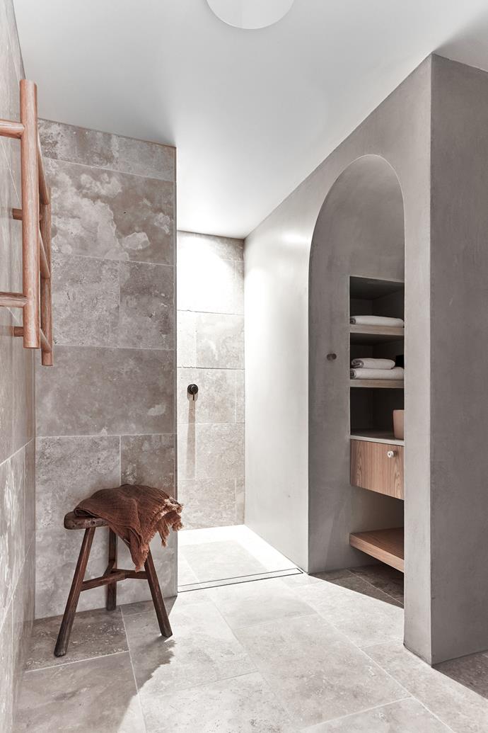 Designed with the same [Surface Society](https://www.surfacesociety.com.au/|target="_blank"|rel="nofollow") travertine tiles and textured wall render seen elsewhere in the home, this room also includes timber cabinetry by Bruce Smith.
