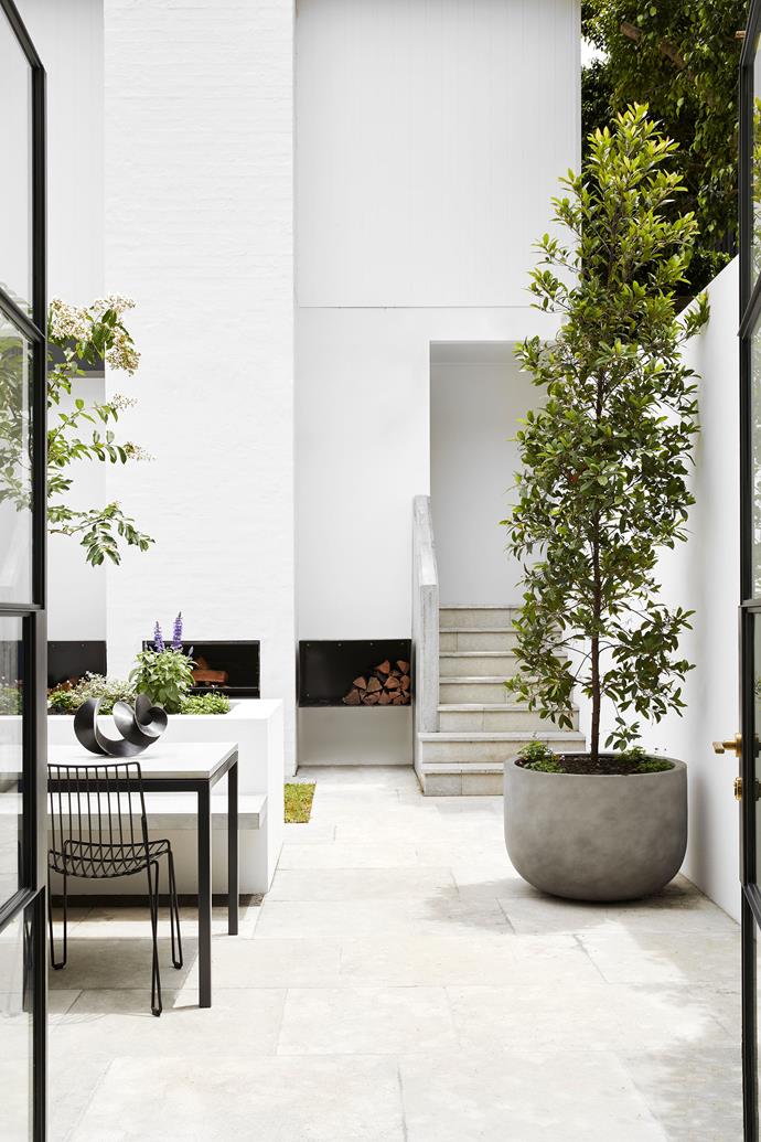 **Indoor-outdoor connection:** A sanctuary for its owners, this inner-city courtyard complete with rustic fireplace and built-in seating provides privacy and serenity. Nestled within a sea of other stately terrace houses in the heart of Sydney, the outdoor room sweeps daylight and verdant vistas into the heritage home. <br> 
*Design by The Unlisted Collective; [theunlistedcollective.com](https://theunlistedcollective.com/|target="_blank"|rel="nofollow")*
