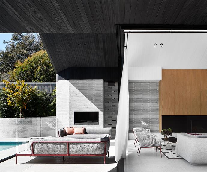 **Indoor-outdoor connection:** With its calming palette, voluptuous sofas and dual fireplaces, the expansive indoor-outdoor room in this Melbourne home is fit for all seasons. "We focused on bringing some of the external architecture elements inside and creating a cohesive relationship," says interior designer Petra Pantano. <br> 
*Design by Studio Petra; [studiopetra.com.au](https://studiopetra.com.au/|target="_blank"|rel="nofollow")*